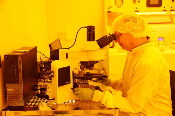 GWNIC staff at a microscope in the cleanroom